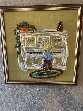 Girl playing piano stitched piece. Framed art.